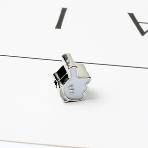 Macro shot of white enamel cartoon glove charm for DIY bracelets in silver finish