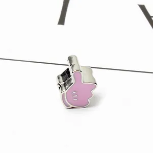 Macro shot of pink enamel thumb glove charm with decorative three-line pattern