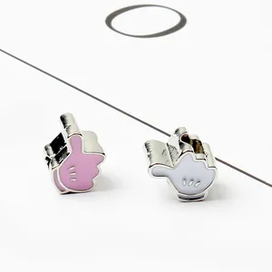 Macro detail of cartoon glove charms with polished enamel finish for DIY jewelry