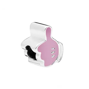 Macro shot of silver thumbs-up glove bead charm with pink enamel for DIY bracelets