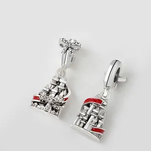 Detailed macro view of silver castle charms with red enamel and shimmering crystal bows