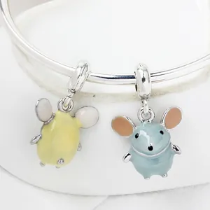 Macro detail of cute enamel mouse pendants with blue and yellow finish on silver bracelet