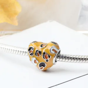 Hartvormige bedel met luipaardprint en geel emaille op een zilveren slangenarmband