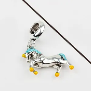 Detail of silver unicorn charm with blue and yellow enamel for DIY jewelry making