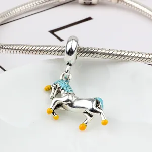 Silver unicorn pendant with blue enamel details on a stylish snake chain bracelet