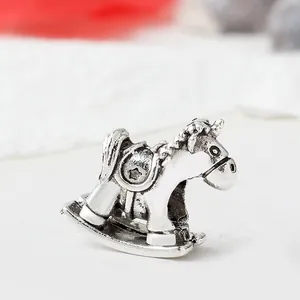 Macro view of vintage silver rocking horse charm with detailed saddle and bridle texture