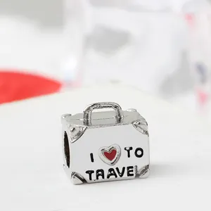 Silver suitcase charm pendant with I Love To Travel engraving and red heart detail