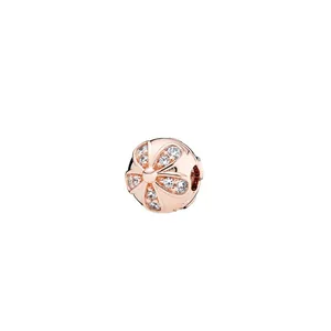 Macro shot of rose gold flower charm with sparkling cubic zirconia for DIY bracelets
