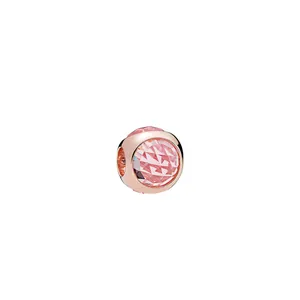 Macro view of rose gold charm bead featuring multifaceted pink crystal for DIY bracelets