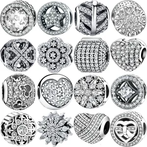 Detailed close-up of 16 assorted silver-plated DIY charms with sparkling cubic zirconia