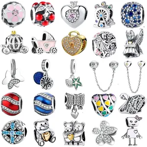 Collection of 25 assorted charms including butterfly, pumpkin coach and floral beads