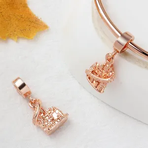 Elegant rose gold castle charms with intricate hollow design on matching bracelet