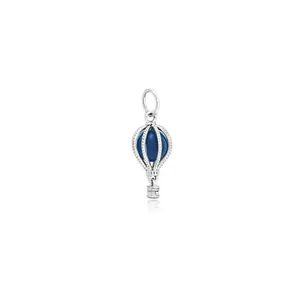 Macro detail of hot air balloon charm with blue bead and silver metal hollow design
