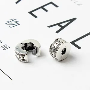 Macro shot of silver star-shaped safety clips with white cubic zirconia for bracelets