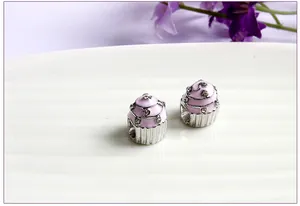 Detailed view of pink cupcake beads with enamel and crystals for charm bracelets
