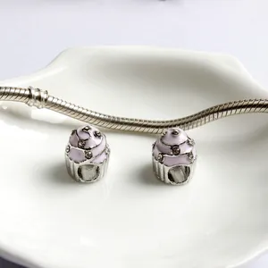 Pink enamel cupcake charms with crystals on a silver snake chain bracelet