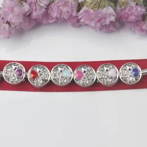Set of six heart enamel and rhinestone beads on a red ribbon with pink floral accents