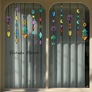 Colorful Ramadan Kareem window stickers with moon, stars, and lanterns on a glass pane