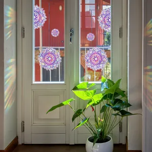 Rainbow holographic mandala window stickers showing sun-catcher effects on white frames