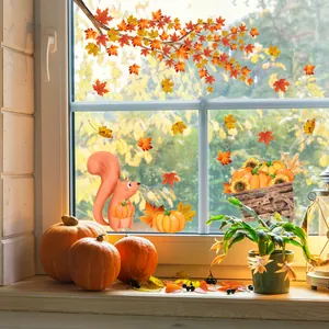 Detail of autumn window decals featuring maple leaves, pumpkins and squirrels on glass