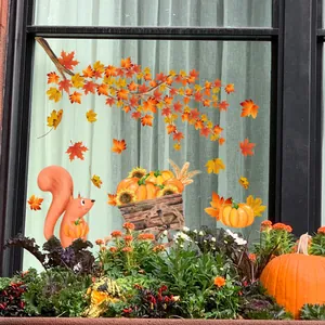 Autumn window decals featuring maple leaves, squirrels, and pumpkins on glass window