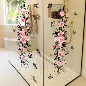 Detail of pink rose and black vine decals on a glass shower door in a modern bathroom