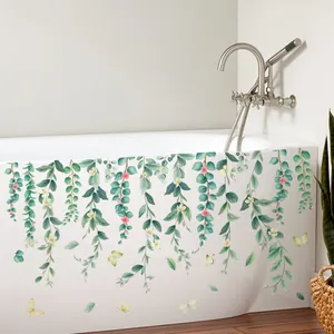 Detailed view of green vine floral stickers with butterflies on a white bathtub surface