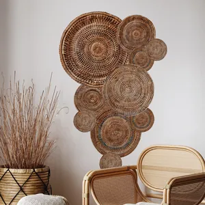 Detailed view of handcrafted bohemian woven rattan wall decor plates on white wall
