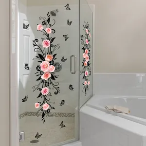 Detail of pink rose and black butterfly floral stickers on a glass shower door