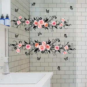 Detail of pink rose and vine wall stickers on bathroom tiles above a sink