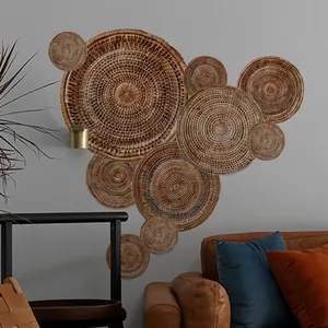 Bohemian rattan wall decor set featuring 10 woven seagrass plates on a minimalist grey wall