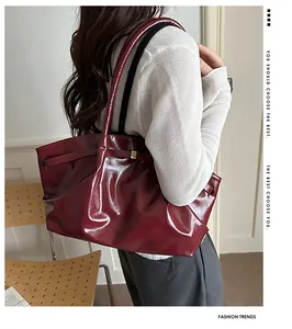 Detailed view of high-gloss burgundy wax leather tote bag with smooth mirror finish
