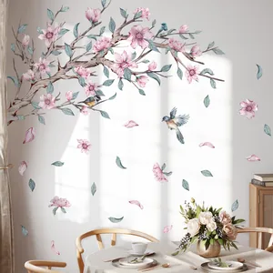 Detail of pink flower branch wall sticker with birds in a sunlit dining room setting