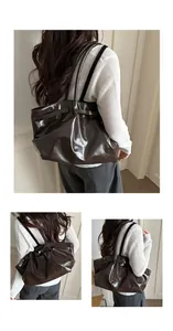 Close-up of model wearing dark brown oil wax leather tote bag with glossy finish
