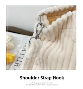 Detailed macro view of the silver metal hook and strap on this off-white corduroy tote
