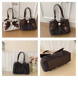 Detail of polka dot tote bag with leather bow, lace trim, and sturdy base structure