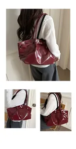 Macro view of burgundy high-gloss tote bag with pleated texture and slim shoulder straps