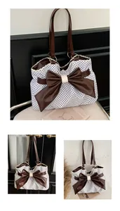 Detailed shot of large polka dot tote bag featuring a leather bow and lace trim edges