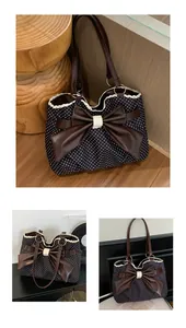 Detailed view of polka dot tote bag featuring a large leather bow and lace trim accents