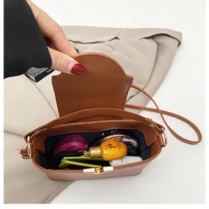 Interior view of brown leather bucket bag showing capacity for cosmetics and skincare