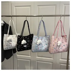 Detail view of large tote bags in four colors with floral prints and plush cloud charms