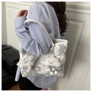 Starry sky pattern tote bag with matching zipper pouch and cloud plush charm detail