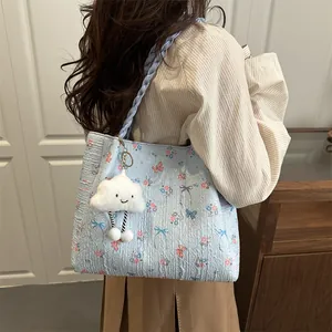 Light blue floral tote bag with butterfly prints and cute cloud pendant on model