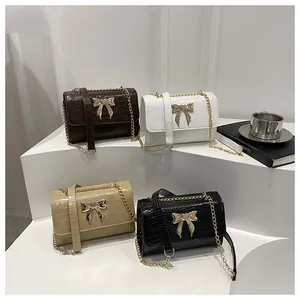 Multi-color view of faux leather crocodile pattern bags with gold bow metal buckles