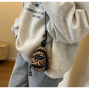 Mini leopard print crossbody bag for girls showing functional zipper and clip detail