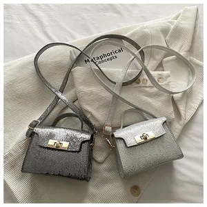 Detailed view of mini square crossbody bags with metallic cracked texture and gold buckle