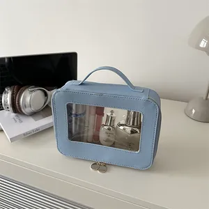 Chic light blue transparent waterproof cosmetic bag with leather texture and top handle