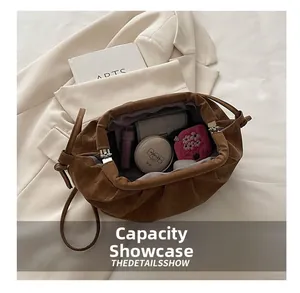 Internal capacity display of the brown pleated dumpling bag showing storage space