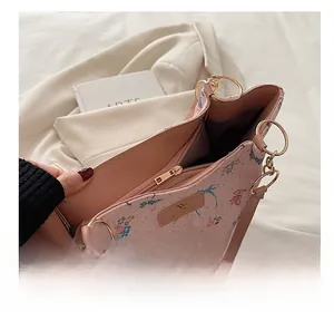 Detail view of pink tote bag with blue butterfly print and smooth metal zipper closure