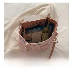 Detailed top view of pink floral tote bag interior showing large capacity and items